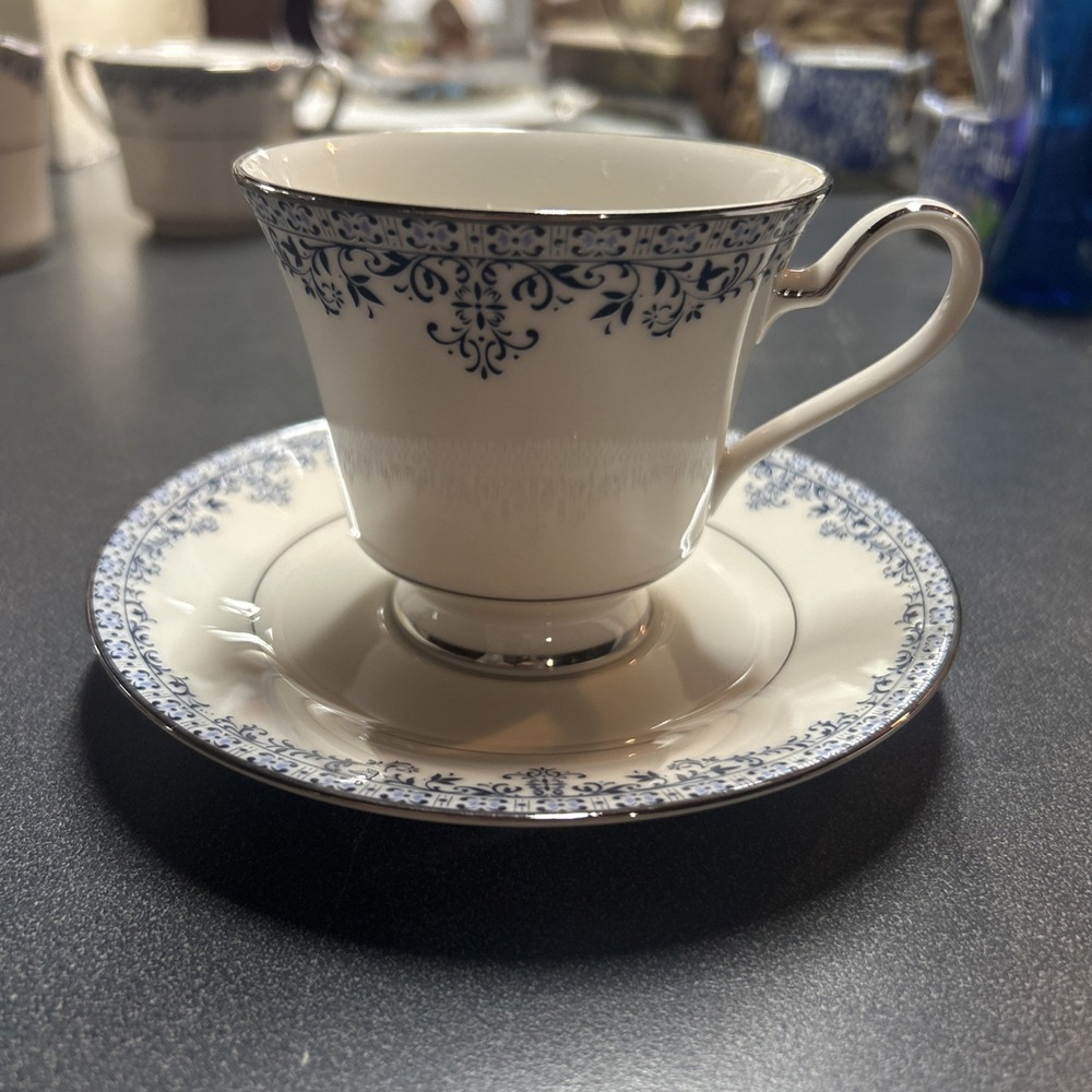 A Noritake Charleston pattern ivory china teacup and saucer set